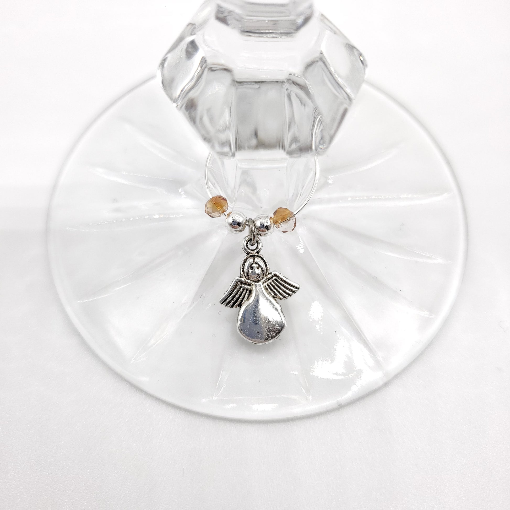 Angel wine glass charm with beads on a wine glass