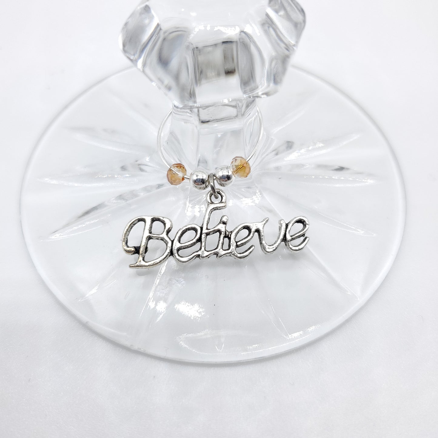 Believe wine charm with beads on a stem of wine glass