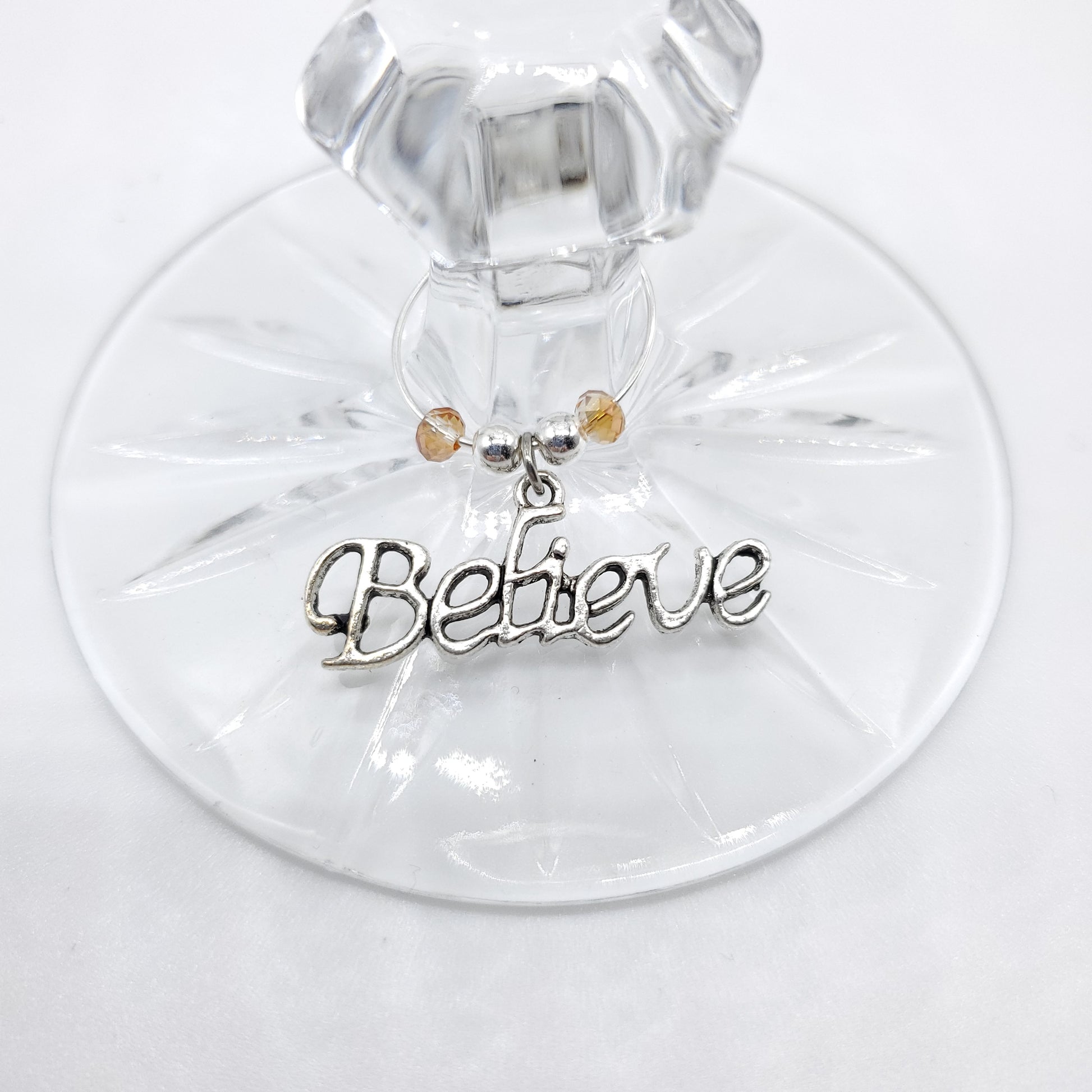 Believe wine charm with beads on a stem of wine glass