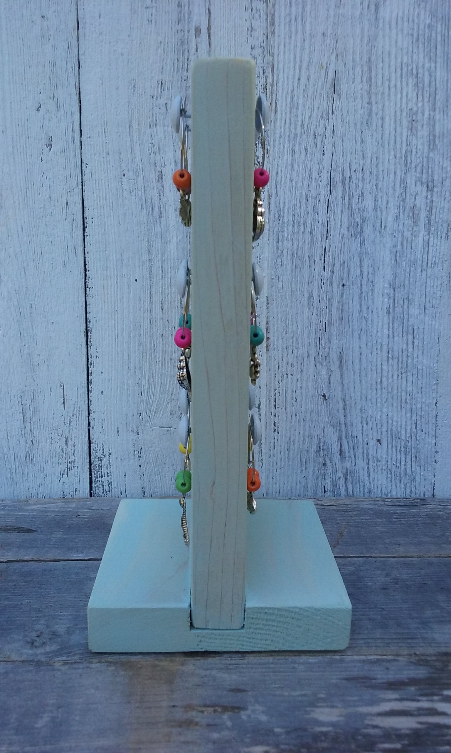 washed turquoise wine charms wooden stand shown sideways with 12 nautical wine charms