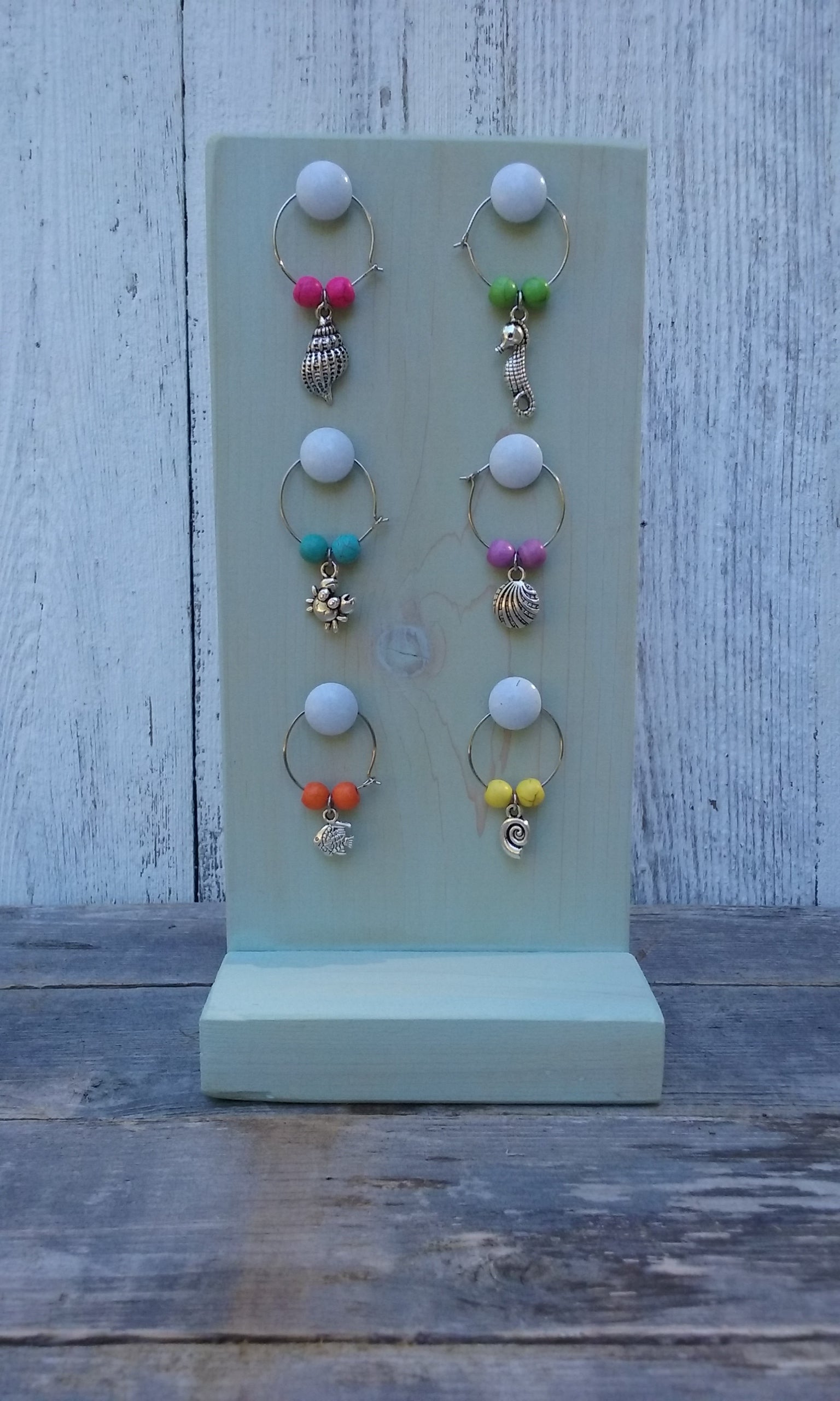 washed turquoise wine charms wooden stand with nautical wine charms