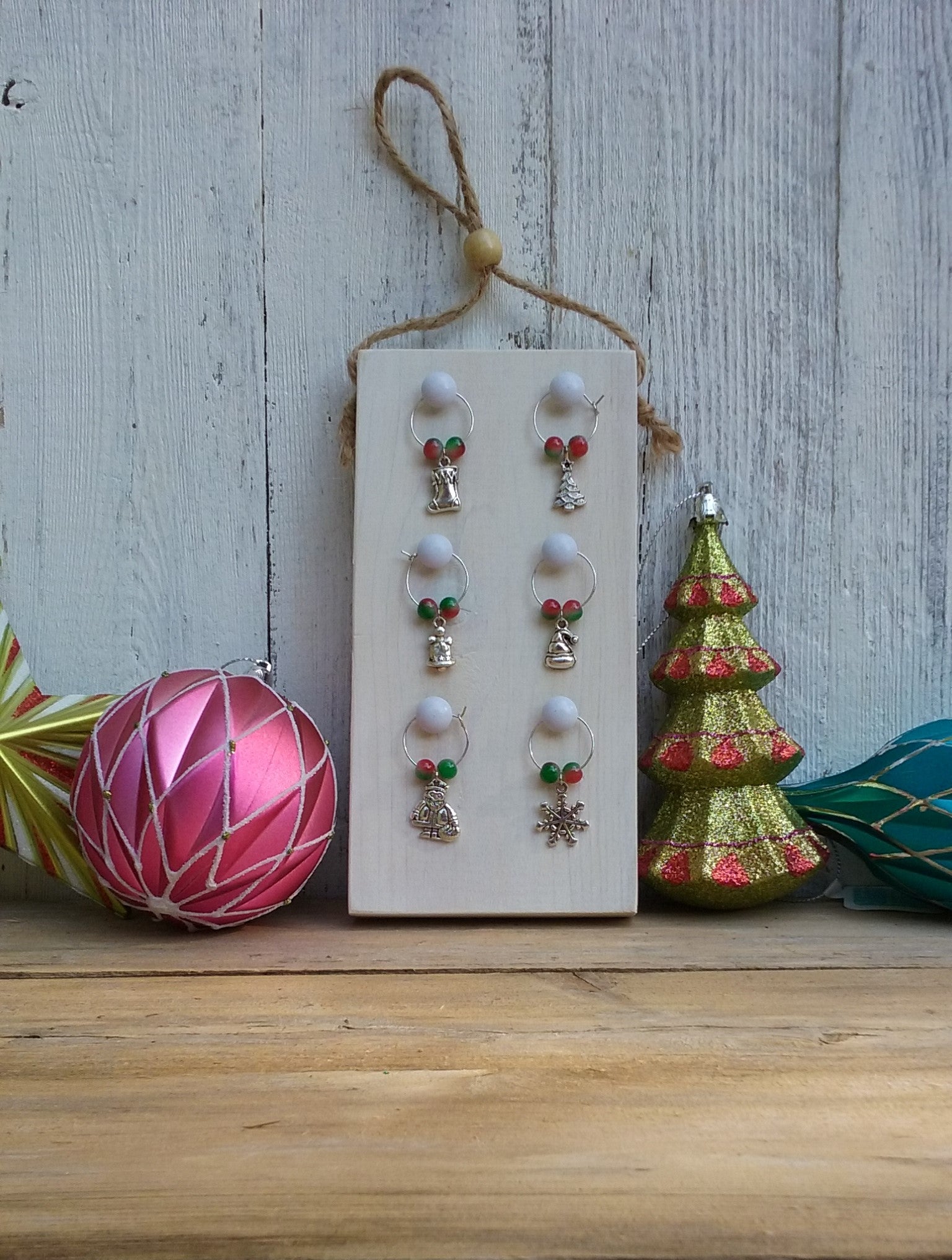 Christmas themed wine charms on wooden display