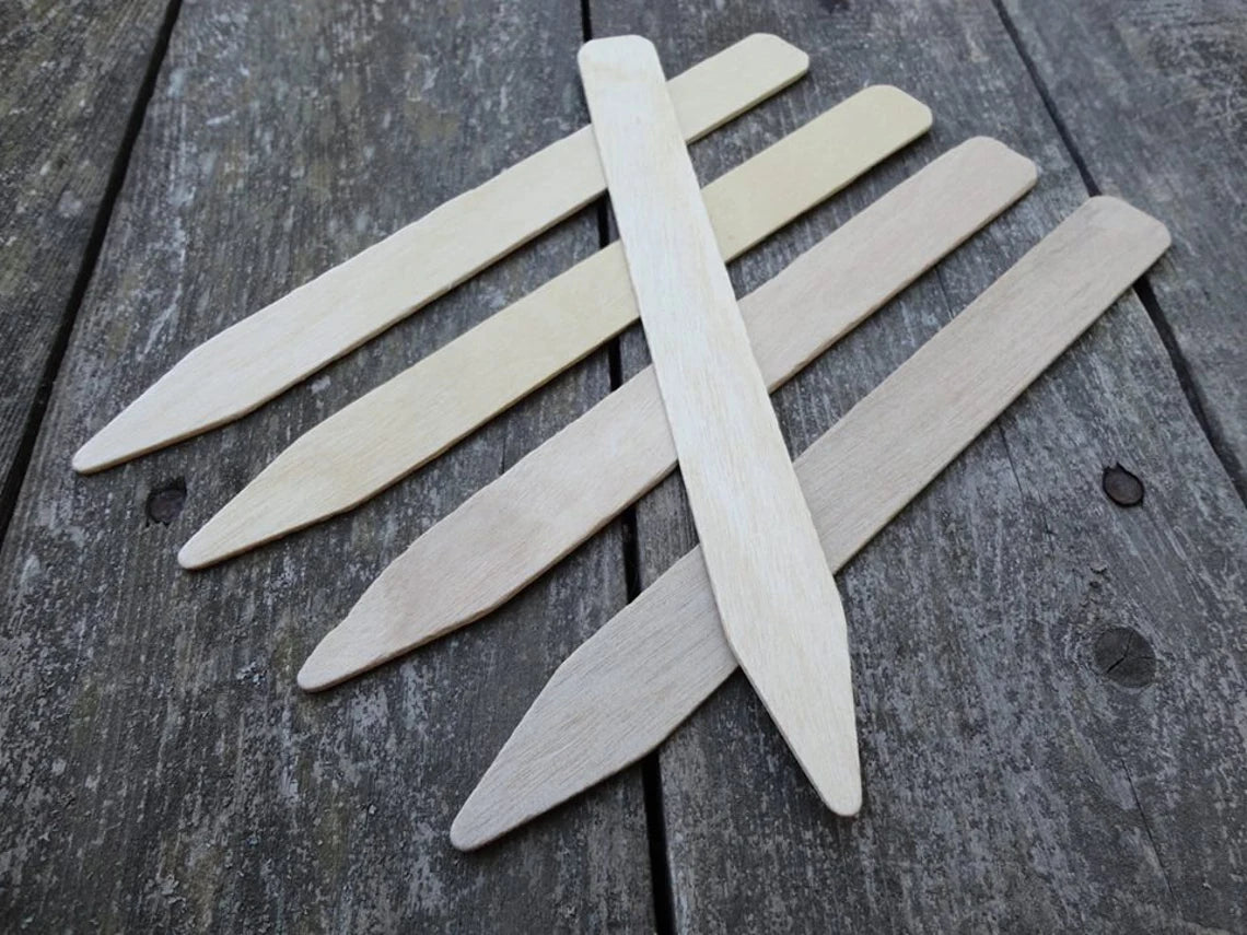 five wooden plant markers